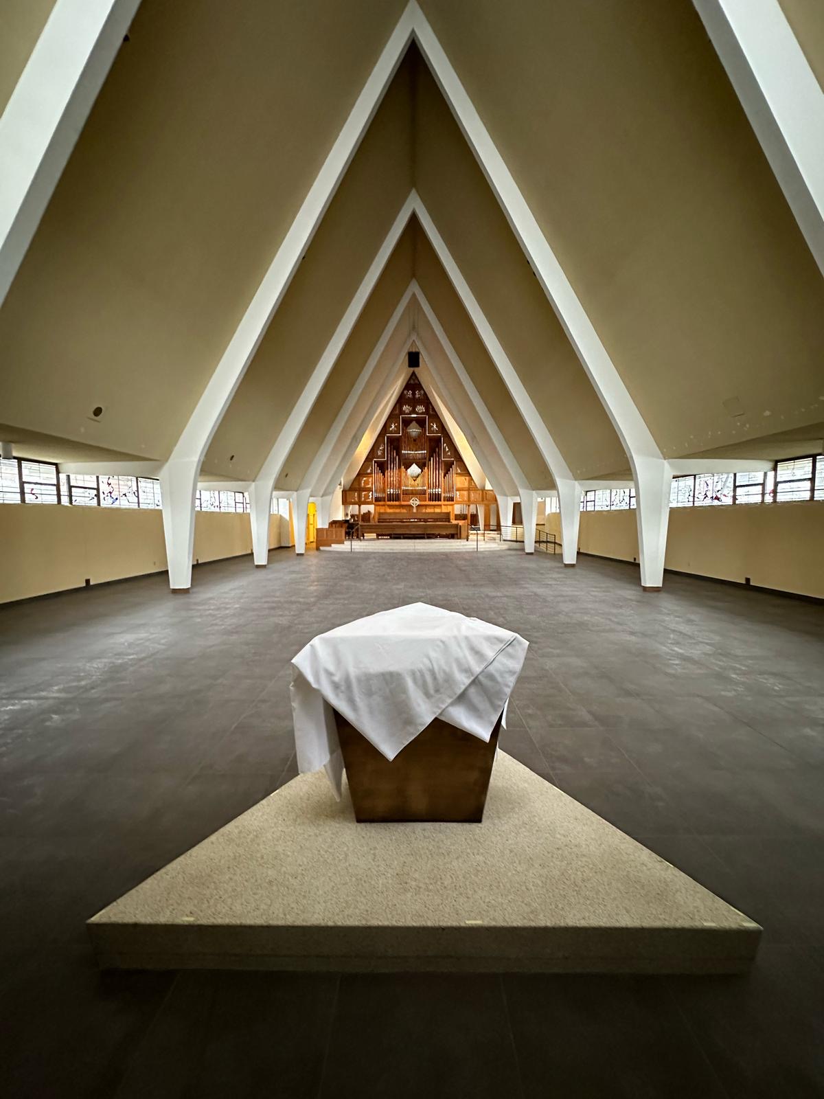 Renovated church sanctuary with vaulted A-frame ceiling and pipe organ