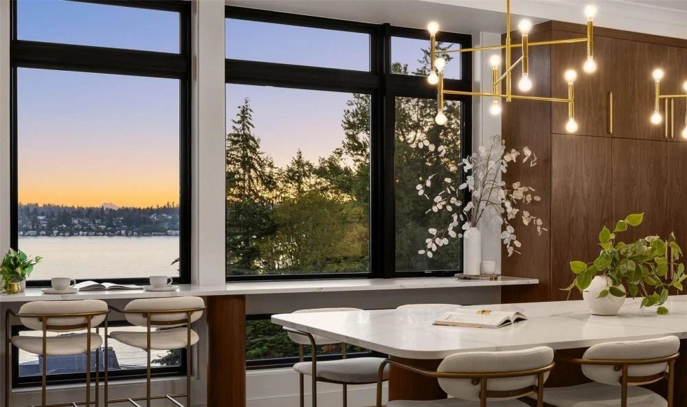Custom kitchen with lake view, walnut cabinetry, and brass chandelier